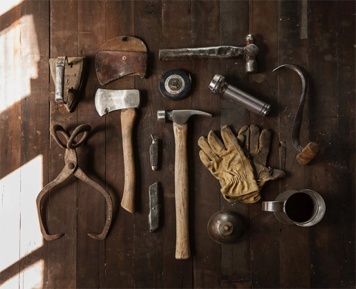 A set of tools on a wooden surface
